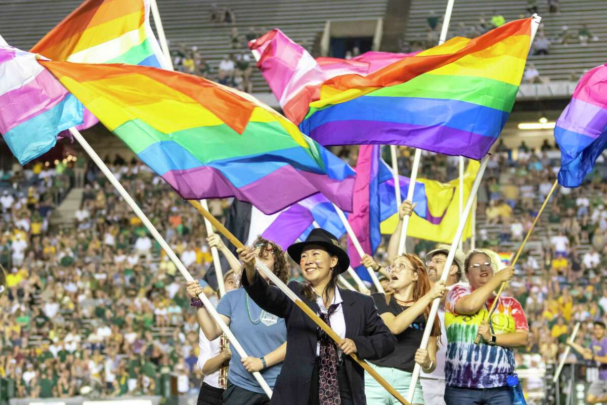 Rice students supporting the LGBTQ community perform with the Rice marching band during half time of a college football game Saturday, Sep 21, 2019, in Houston.