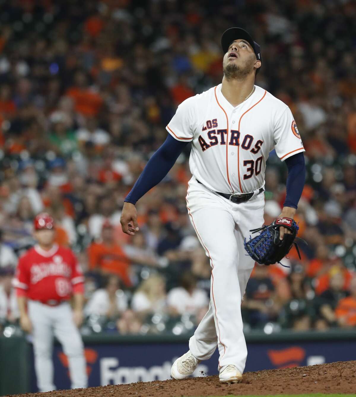 Houston Astros relief pitcher Hector Rondon (30) watches Los Angeles Angels Kole Calhoun's home run ball go over his head in the ninth inning of an MLB baseball game at Minute Maid Park, Saturday, Sept. 21, 2019, in Houston.