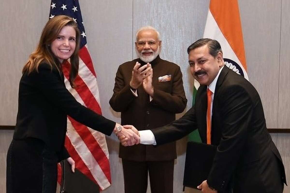 Meg Gentle, CEO of Houston liquefied natural gas company Tellurian, shakes hands with Prabhat Sing, CEO of Petronet LNG. while Indian Prime Minister Narendra Modi applauds. The $2.5 billion deal between Tellurian and Petronet is being described as one of the largest liquefied natural gas deals in U.S. history.