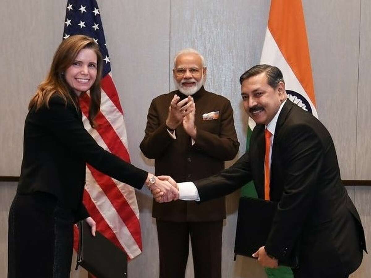 Meg Gentle, CEO of Houston liquefied natural gas company Tellurian, shakes hands with Prabhat Sing, CEO of Petronet LNG. while Indian Prime Minister Narendra Modi applauds. The $2.5 billion deal between Tellurian and Petronet is being described as one of the largest liquefied natural gas deals in U.S. history.