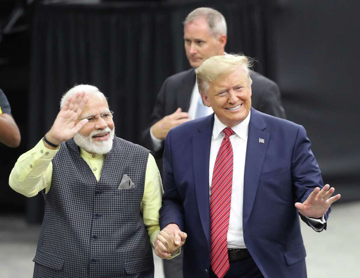 India's prime minister, Narendra Modi and President Donald Trump walk hand and hand around NRG Stadium after the Howdy Modi event Sunday, Sept. 22, 2019, in Houston.