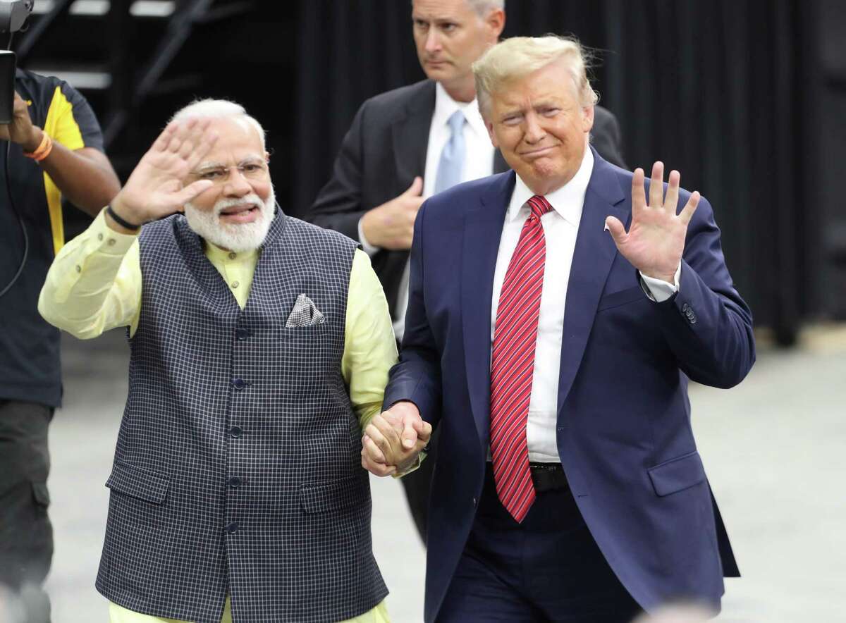 India's prime minister, Narendra Modi and President Donald Trump walk hand and hand around NRG Stadium after the Howdy Modi event Sunday, Sept. 22, 2019, in Houston.