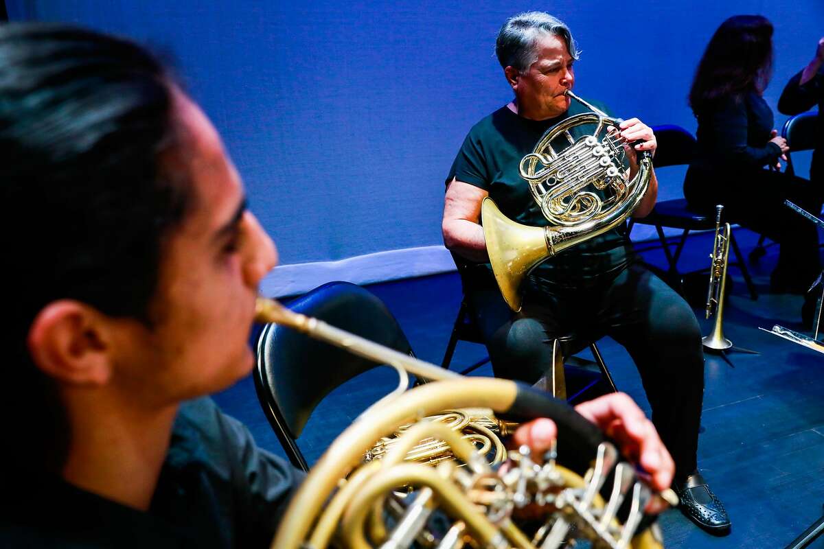 (l-r) Mychal Nishimura and MaryJane Evans warm up before performing with the Presidio Pop-Up Orchestra at the open house for the Presidio Theatre which opened for the first time in 24 years after undergoing renovations in San Francisco, California, on Sunday, Sept. 22, 2019.