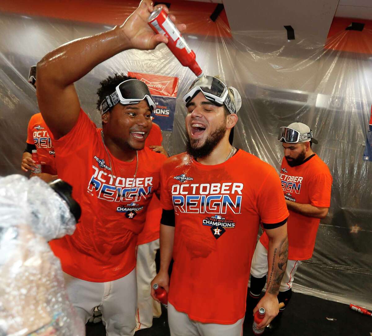 Houston Astros Framber Valdez pours beer on Roberto Osuna as the team celebrated the team's win and clinching the AL West crown after an MLB baseball game at Minute Maid Park, Sunday, Sept. 22, 2019, in Houston.