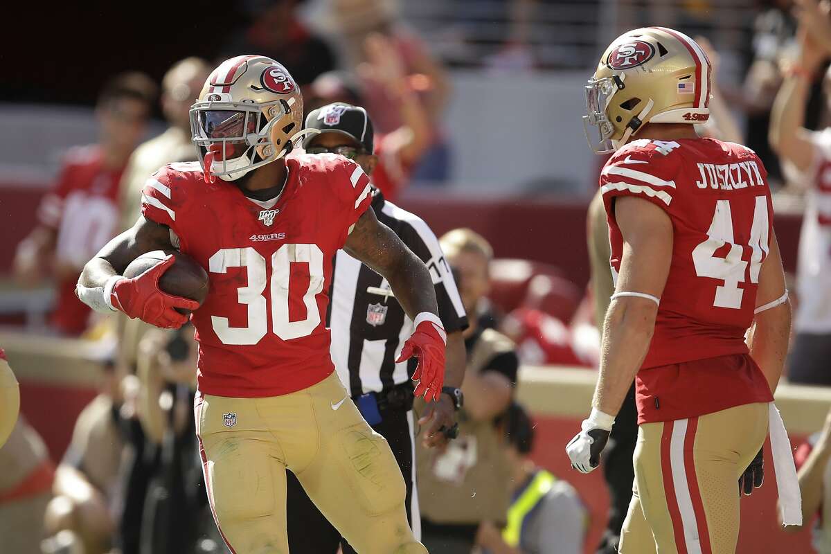 Jeff Wilson Jr. #30 of the San Francisco 49ers runs with the ball