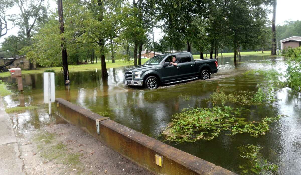 A truck slowly makes its way through a flooded yard and driveway on Sargent in Vidor as the process of recovery from Imelda's torrential rains and flooding begins throughout the region Friday. Photo taken Friday, September 20, 2019 Kim Brent/The Enterprise