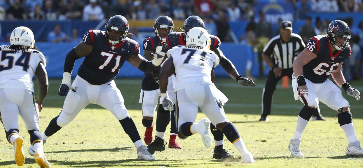 Houston Texans offensive tackle Tytus Howard (71) and center Nick Martin (66) drop back to pass block for quarterback Deshaun Watson (4) against the Los Angeles Chargers during the fourth quarter of an NFL football game at Dignity Health Sports Park on Sunday, Sept. 22, 2019, in Carson, Calif.