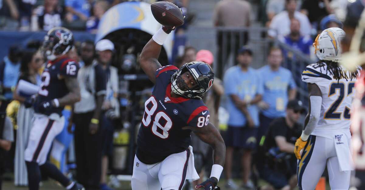 Houston Texans tight end Jordan Akins (88) spikes the ball after scoring on a 15-yard touchdown reception against the Los Angeles Chargers during the third quarter of an NFL football game at Dignity Health Sports Park on Sunday, Sept. 22, 2019, in Carson, Calif.