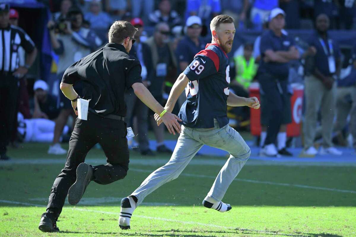 Security chases a fan who ran onto the field during the second half of an NFL football between the Los Angeles Chargers and the Houston Texans game Sunday, Sept. 22, 2019, in Carson, Calif. (AP Photo/Mark J. Terrill)