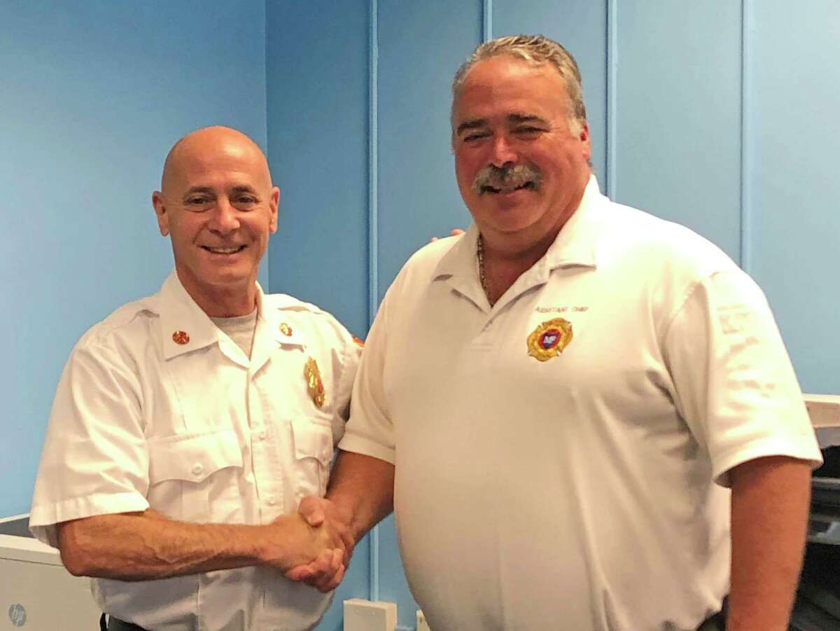 Assistant Fire Chief Gary Baker, right, is with Fire Chief Doug Edo as Baker retired recently from the Milford Fire Department.