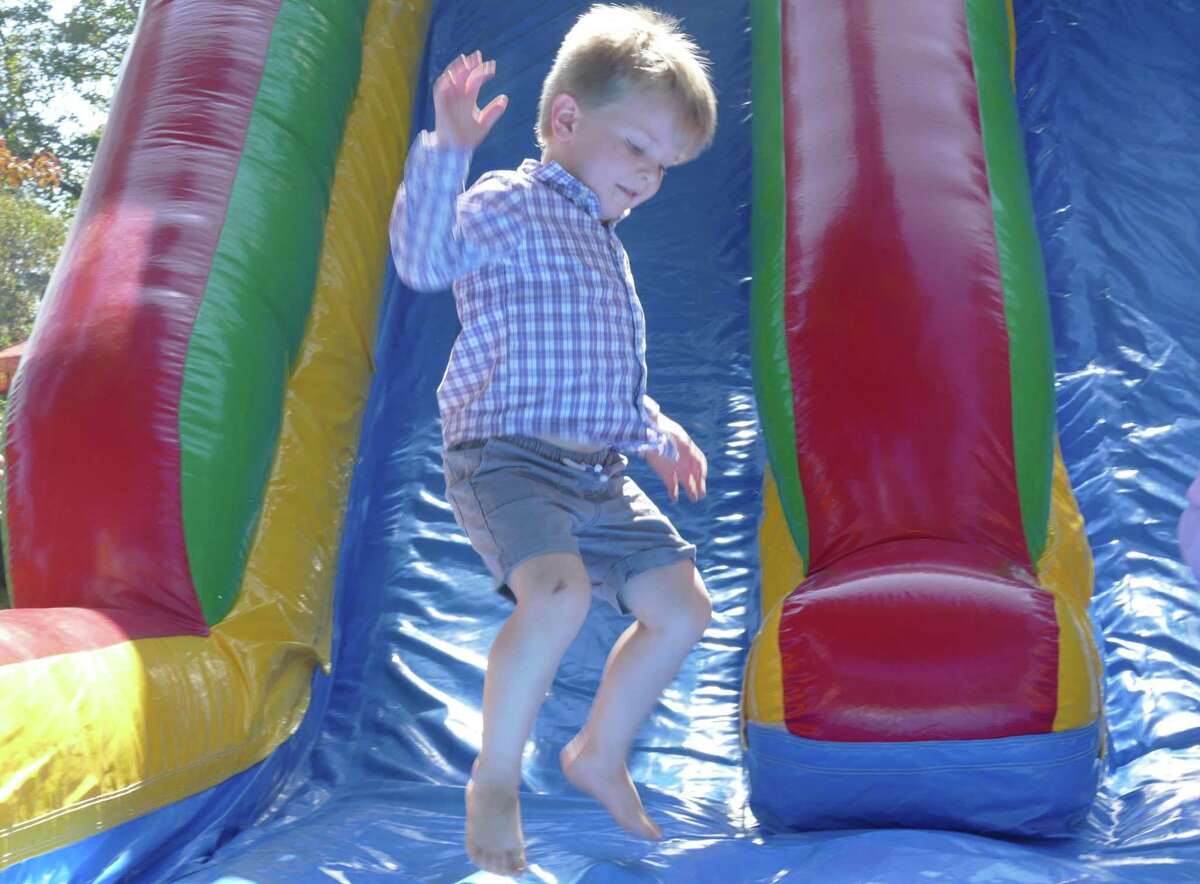 A young slider pops up from an inflatable course during Family Fun Day in Ridgefield on Sunday, Sept. 22.