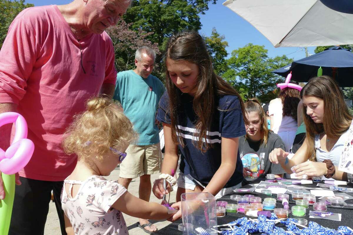 Eva, 3, receives a purple fairy tattoo at Family Fun Day in Ridgefield on Sunday, Sept. 22, 2019.