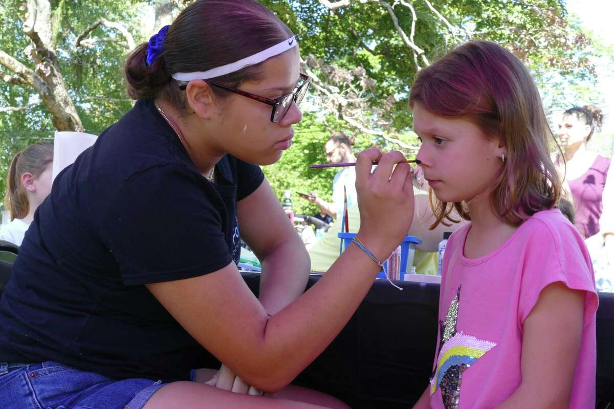 A young Ridgefield girl gets her face painted during Family Fun Day at Lounsbury House.