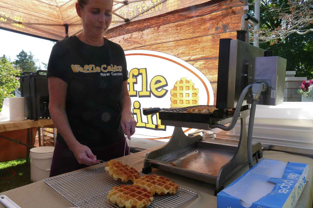 Corey Londoner makes waffles for Waffle Cabin at Family Fun Day at the Lounsbury House on Sunday, Sept. 22.
