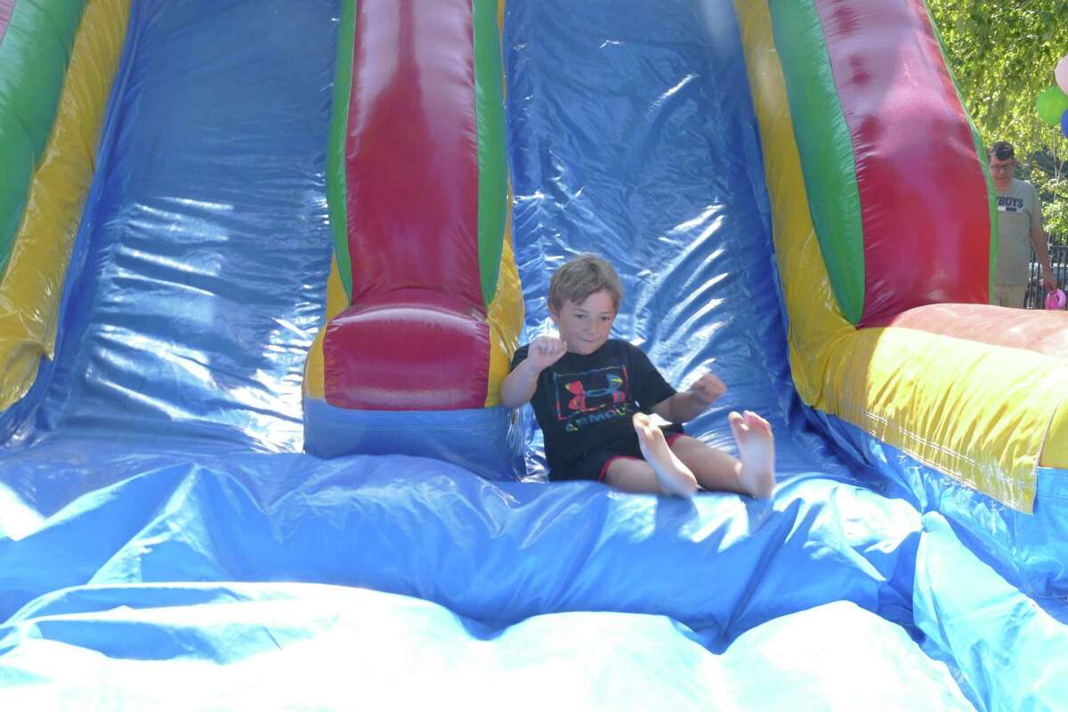 A young slider pops up from an inflatable course during Family Fun Day in Ridgefield on Sunday, Sept. 22.