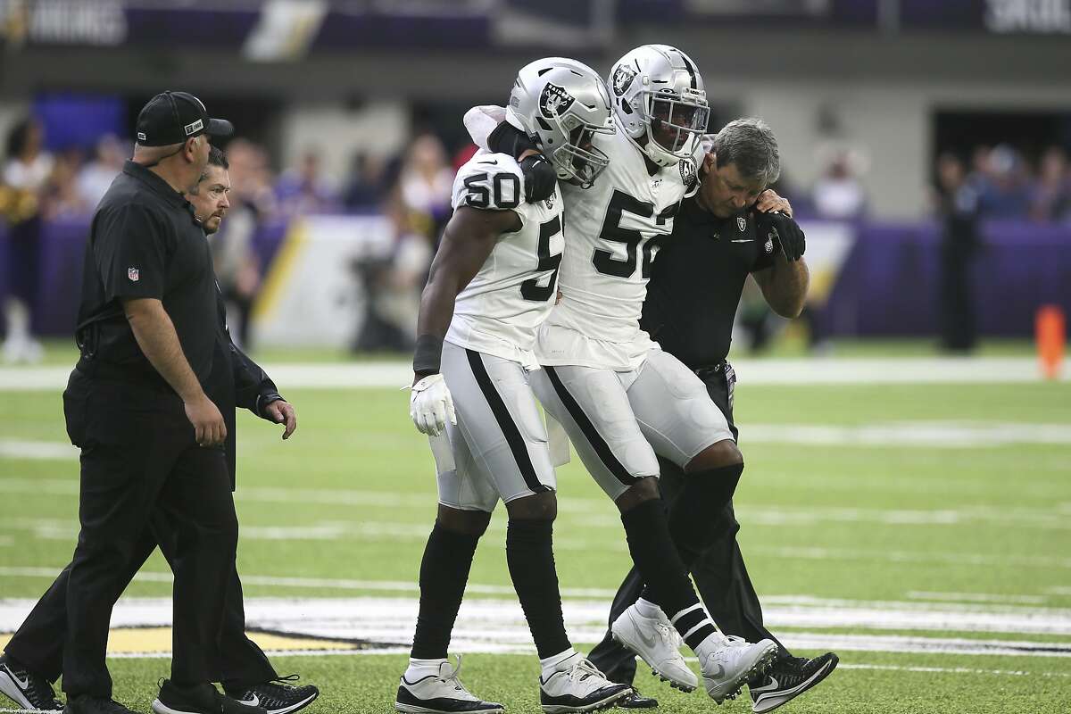 Oakland Raiders middle linebacker Marquel Lee (52) is helped off the field after getting injured during the first half of an NFL football game against the Minnesota Vikings, Sunday, Sept. 22, 2019, in Minneapolis. (AP Photo/Jim Mone)