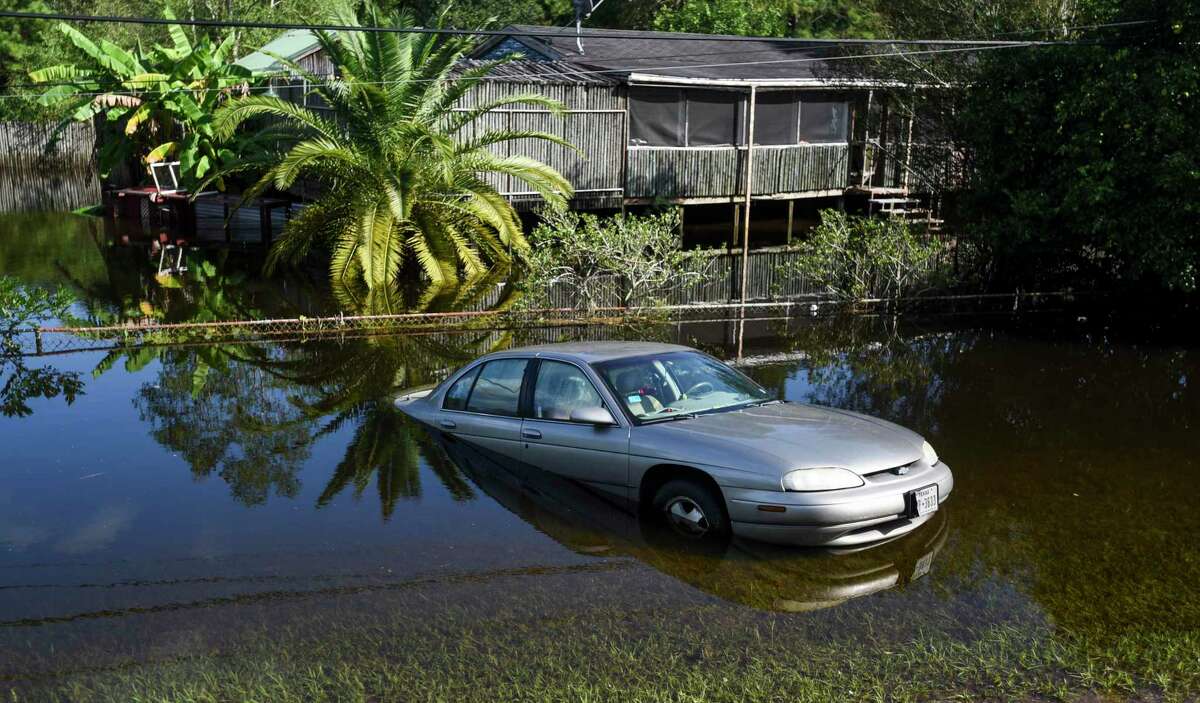 A car sits abandon off of flooded Texas 124 near Fannett Sunday. Photo taken on Sunday, 09/22/19. Ryan Welch/The Enterprise