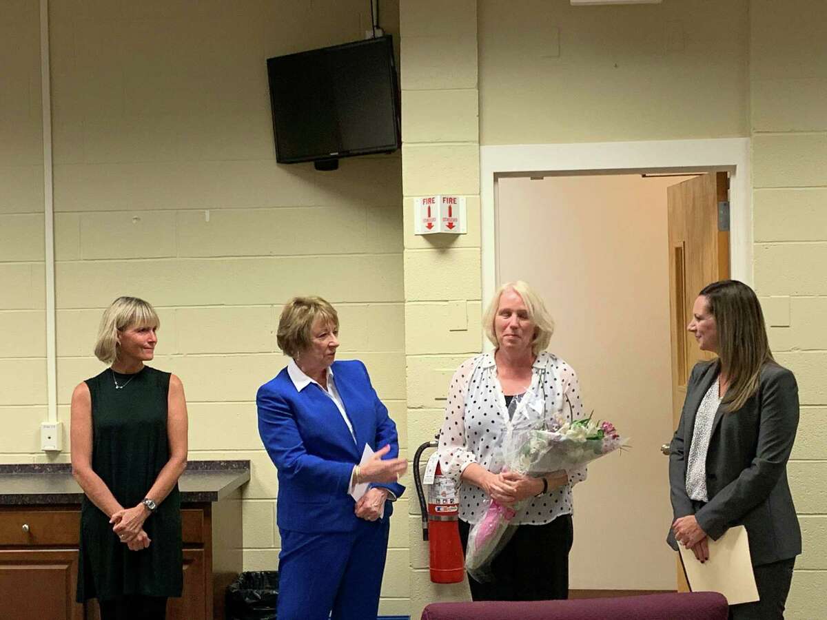 Scotland Elementary School paraeducator Alyce Rae, clutching flowers, was recognized as 2020 Paraeducator of the Year for Ridgefield Public Schools at the Board of Education’s September 23 meeting. From left to rigth: Board chair Margaret Stamatis, Interim Superintendent JeanAnn Paddyfote, Rae, and Scotland Principal Jill Katkocin.