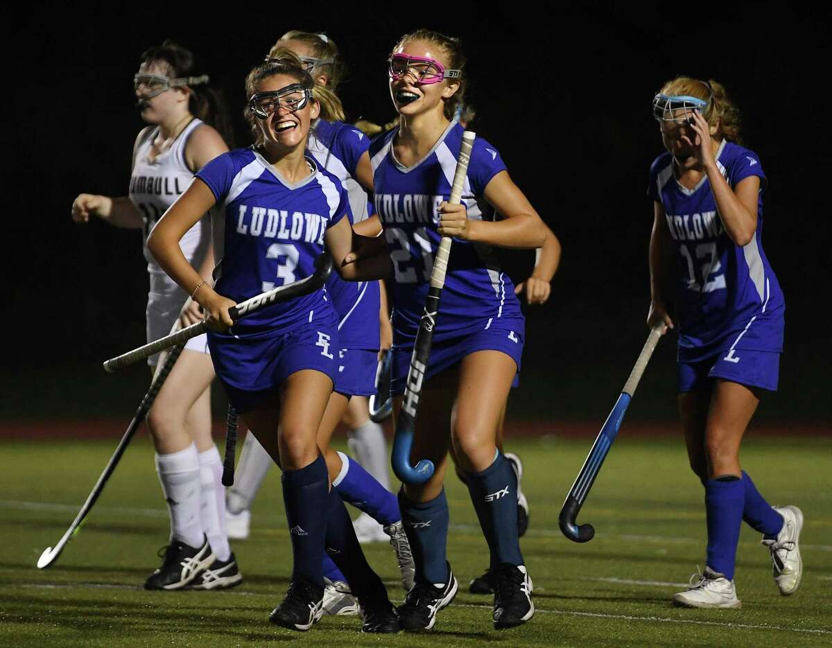From left; Fairfield Ludlowe's Bridget O'Brien and Emma O'Neil celebrate a goal by teammate Chloe Madzio in the first half of their FCIAC field hockey game at Trumbull High School in Trumbull, Conn. on Monday, September 23, 2019.