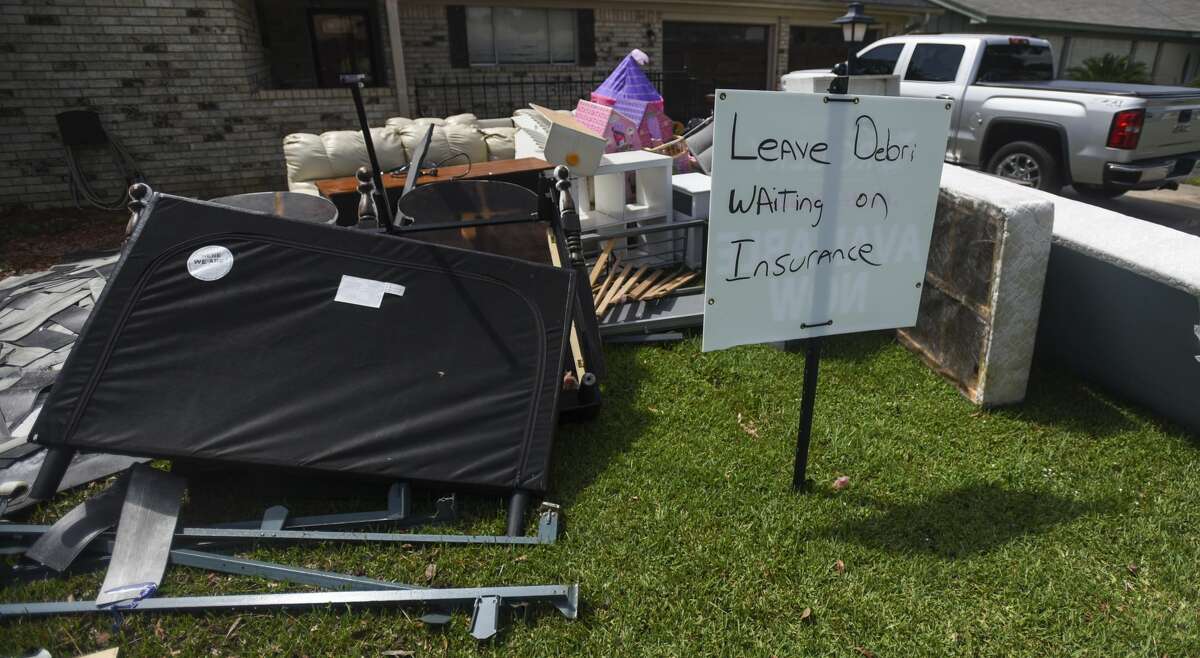 A sign that reads "Leave Debris Waiting on Insurance" sits in the front yard of Erika Szudzik house in Nederland Monday. Photo taken on Monday, 09/23/19. Ryan Welch/The Enterprise