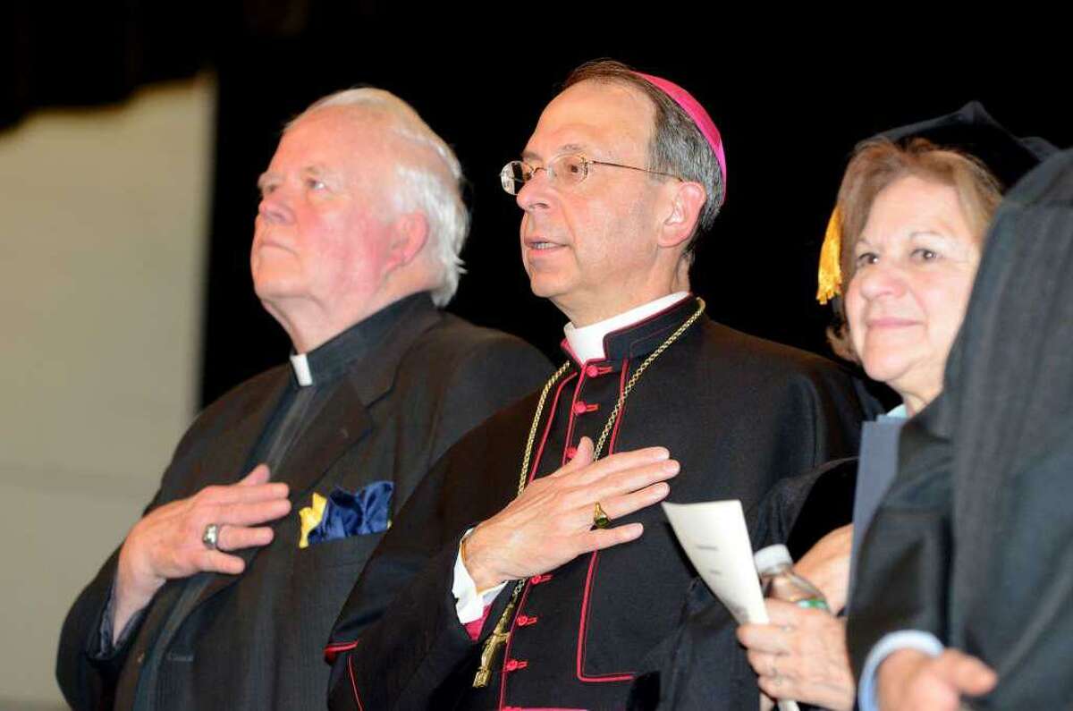 Reverend Bill Sangiovanni, President of Notre Dame Catholic High School, Bishop William Lori and Superintendent Margaret Dames stand during the National Anthem during the 2011 Notre Dame Catholic High School Commencement at Notre Dame in Fairfield on Saturday, June 4, 2011.