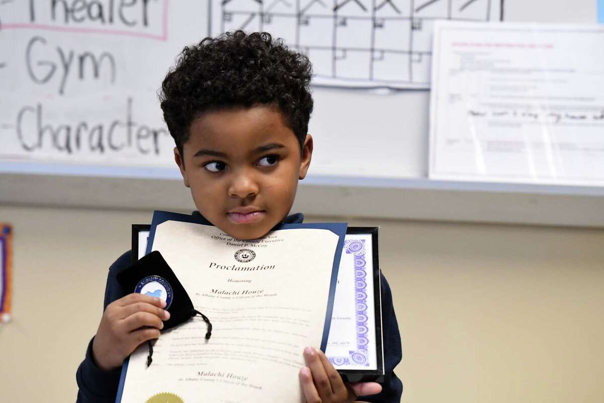 Malachi Houze, 5, holds his Citizen of the Month award he received from Albany County Executive Daniel McCoy and County Clerk Bruce Hidley for his work feeding the homeless on Tuesday, Sept. 24, 2019, at the Brighter Choice Charter School in Albany, N.Y. (Will Waldron/Times Union)