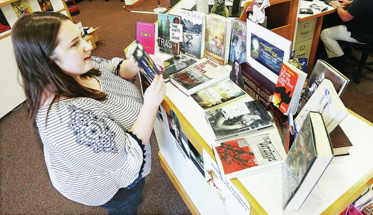 Morgan Berry, Hayner Library circulation manager, works with a display she set up for Banned Books Week in the downtown library branch on Belle Street in Alton. The annual event, Sept. 22-28, is sponsored by the American Library Association.