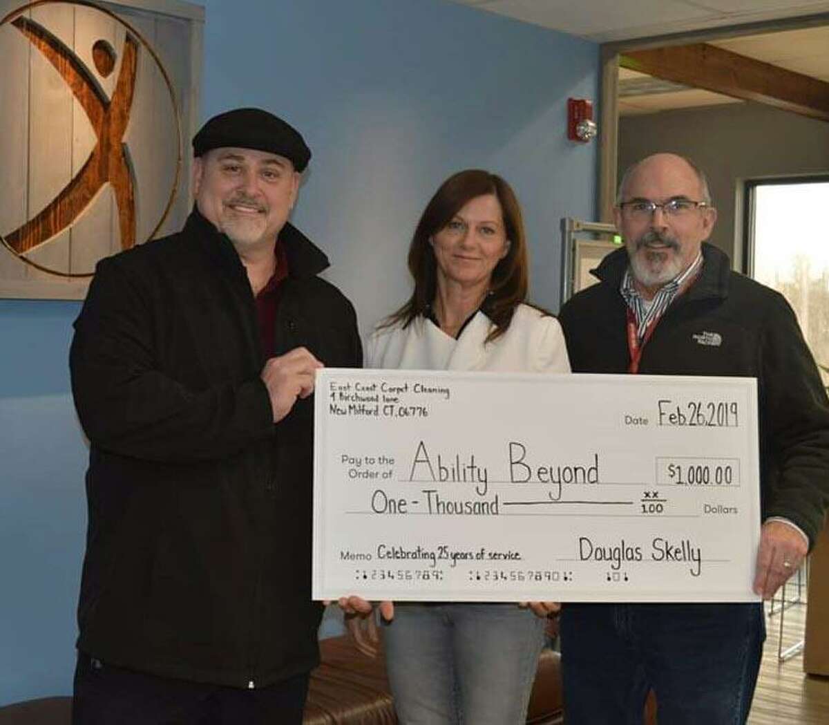 Doug Skelly, left, owner of East Coast Carpet and Upholstery Cleaning in New Milford recently presented a $1,000 donation to Ability Beyond.