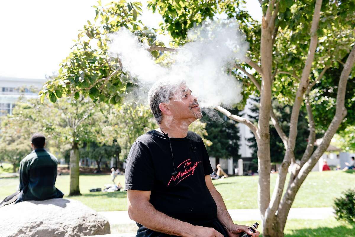 Marcus Davis uses a vaporizer while sitting in Yerba Buena Gardens in San Francisco, Calif. on Wednesday, Sept. 11, 2019. Marcus started using vaporizers over 6 years years ago to help him quit his 30 year addiction to smoking cigarettes.