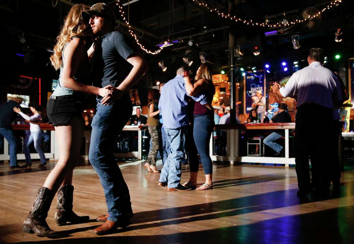 Jett Wiggins of Lubbock, Texas dances with McKenzie Moore of Ropesville, Texas at Mo's Place in Katy.