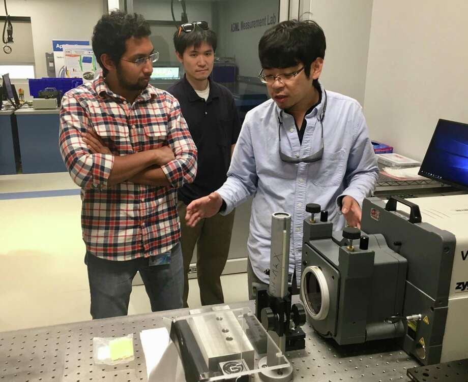 Shaun Chen, right, shows an interferometer machine that measures the quality and characteristics of precision optics, as Guru Pandian (left) looks on, at the newly opened testing lab at ASML in Wilton, Conn., on Thursday, Sept. 6, 2018. Photo: Dan Haar / Hearst Connecticut Media / Stamford Advocate