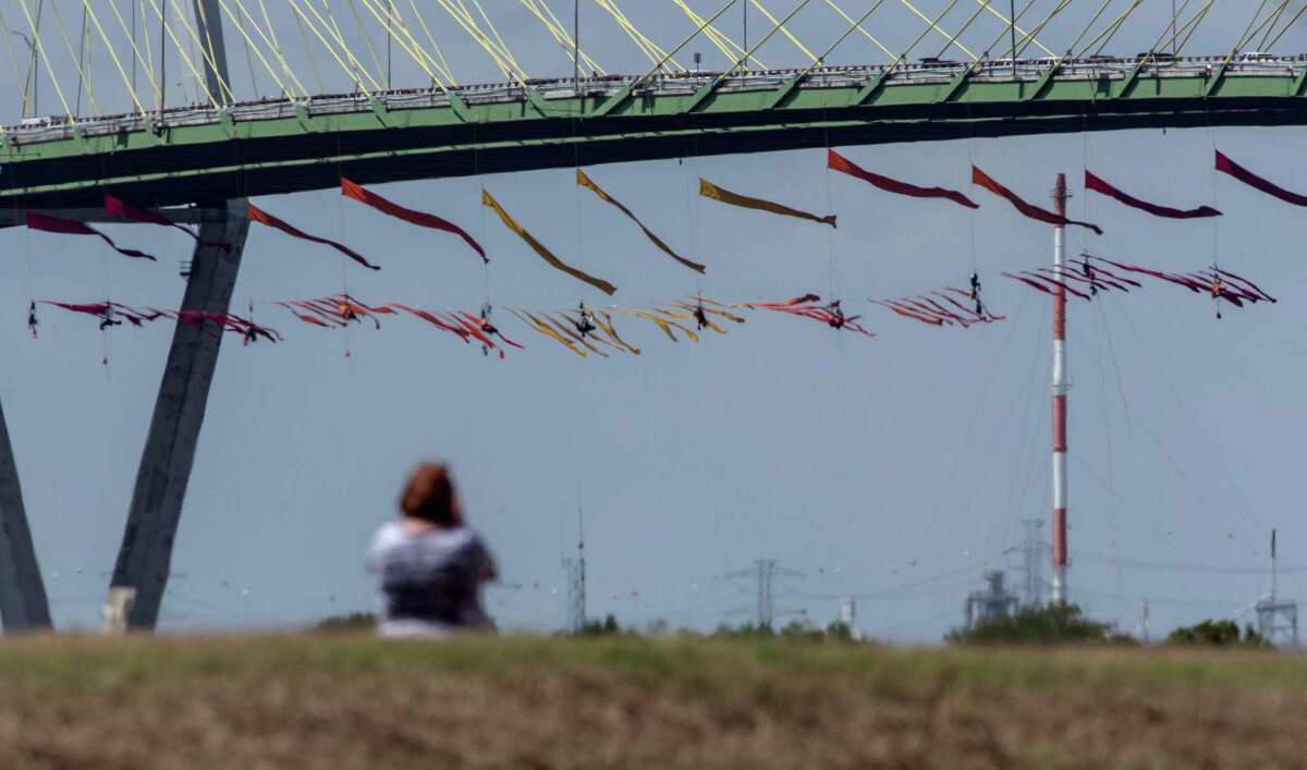 Greenpeace USA protesters dangle from the Fred Hartman Bridge, Thursday, Sept. 12, 2019, in Baytown, Texas.