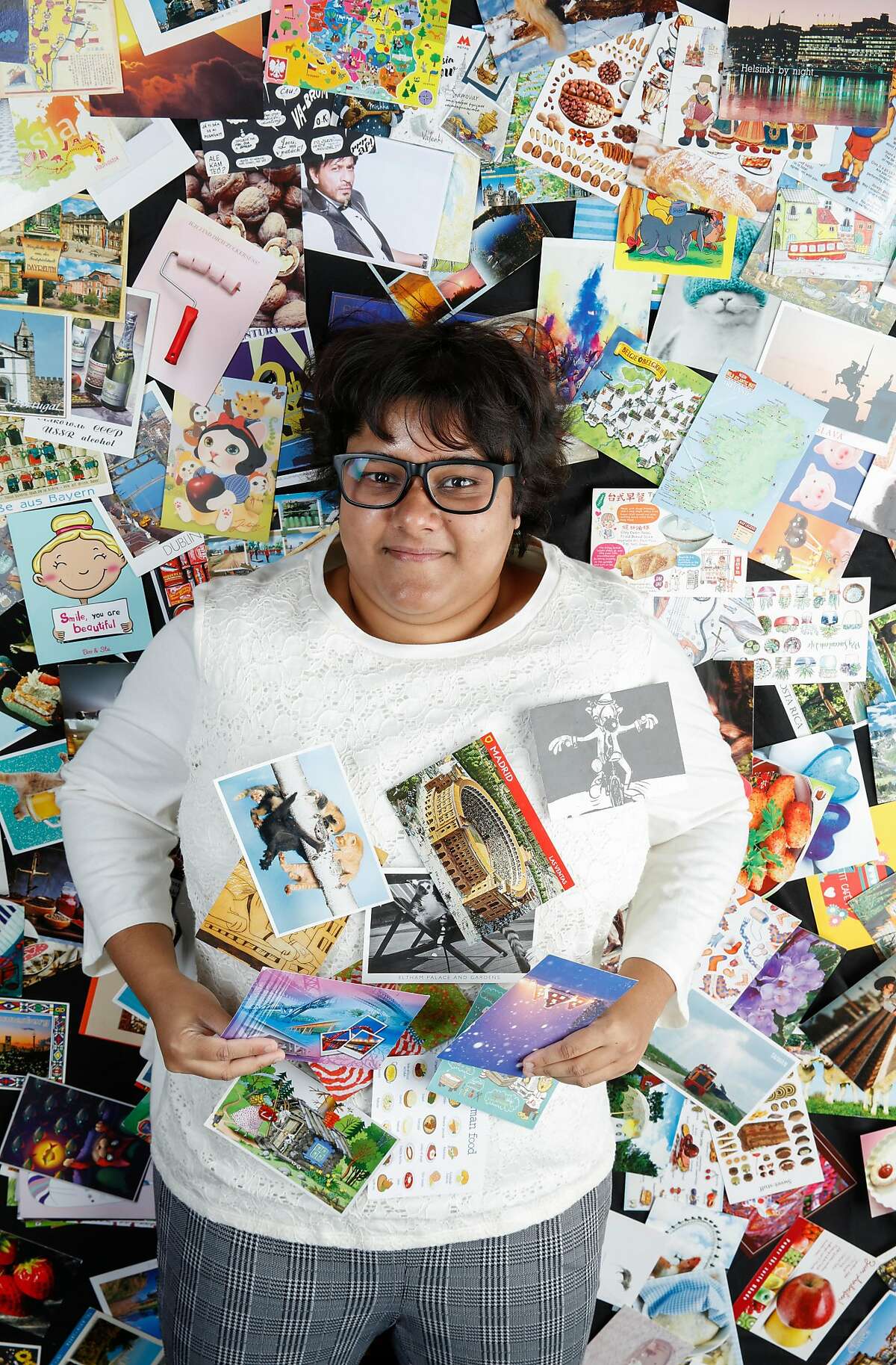 Rumana Sultana, seen on Monday, Sept. 23, 2019 in San Francisco, Calif., has amassed a collection of over 3,000 postcards from around the world in the 13 years she has been collecting them.