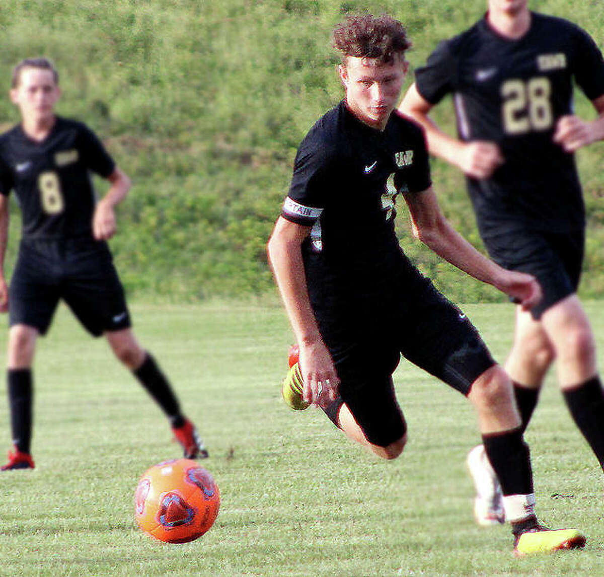East Alton-Wood River’s Ethan Moore (4) moves the ball during Tuesday’s 2-1 victory over Carlyle at Wood River Soccer Park. Moore scored both Oilers goals and has scored 28 on the season.