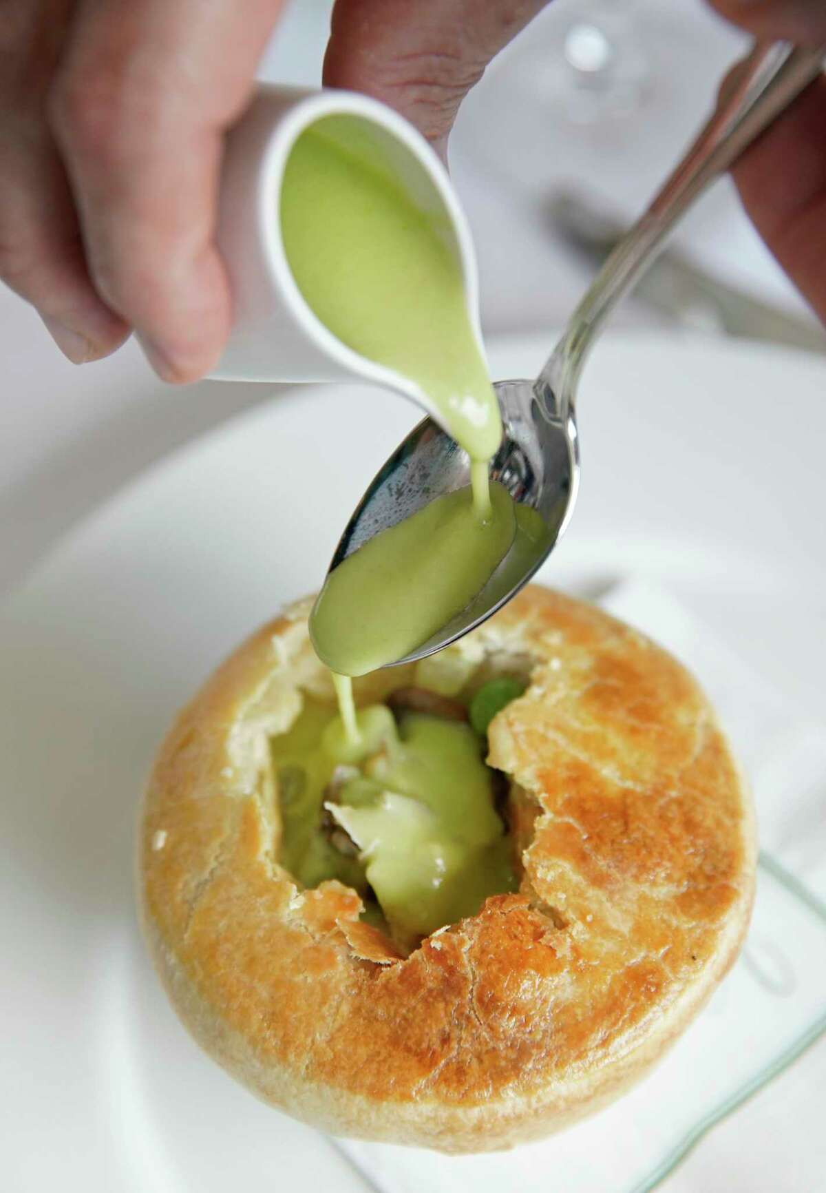 The finishing touch is added tableside to the rabbit pot pie at The Annie Cafe & Bar.