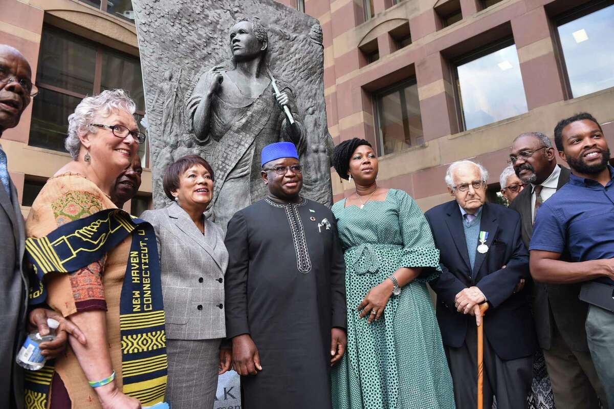 From left, Althea Norcott, New Haven Mayor Toni Harp, Sierra Leone President H.E. Julius Maada Bio and First Lady H.E. Fatima Maada Bio, Al Marder and others are photographed at City Hall in New Haven in front of the Amistad Memorial featuring Joseph Cinque on September 24, 2019.