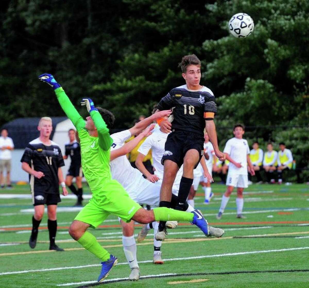 Trumbull's Tiago Frazao heads home the Eagles' second goal in their 2-2 draw with Staples.