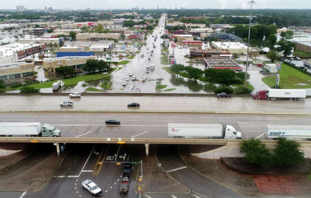 Interstate 10 is nearly vacant and traffic moves slowly along a flooded College Street Thursday after Tropical Storm Imelda hit Southeast Texas. Photo taken Thursday, 9/19/19
