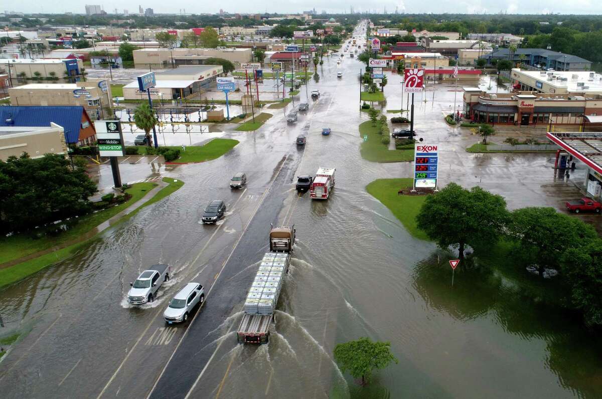Traffic moves slowly along a flooded College Street Thursday after Tropical Storm Imelda hit Southeast Texas. Photo taken Thursday, 9/19/19
