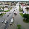 Traffic moves slowly along a flooded College Street Thursday after Tropical Storm Imelda hit Southeast Texas. Photo taken Thursday, 9/19/19