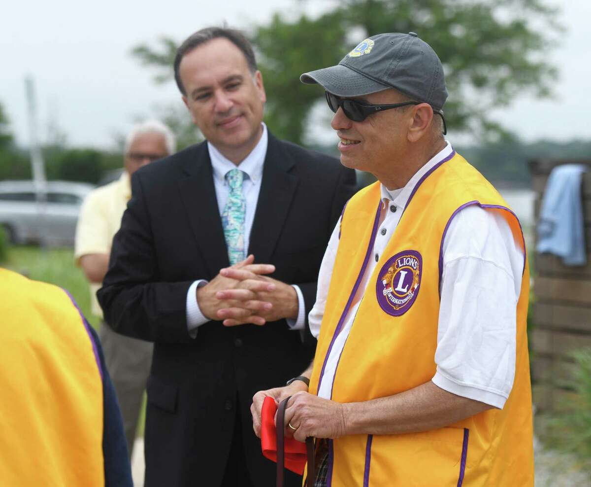 Alan Gunzburg, right, who serves on the First Selectman’s Advisory Committee for People with Disabilities, chats with First Selectman Peter Tesei during the ribbon-cutting for the new ADA accessible ramp on the Greenwich Point Park beach in Old Greenwich, Conn. Wednesday, June 19, 2019. The new accessible beach mat will make it far easier for people with disabilities to get to the beach.