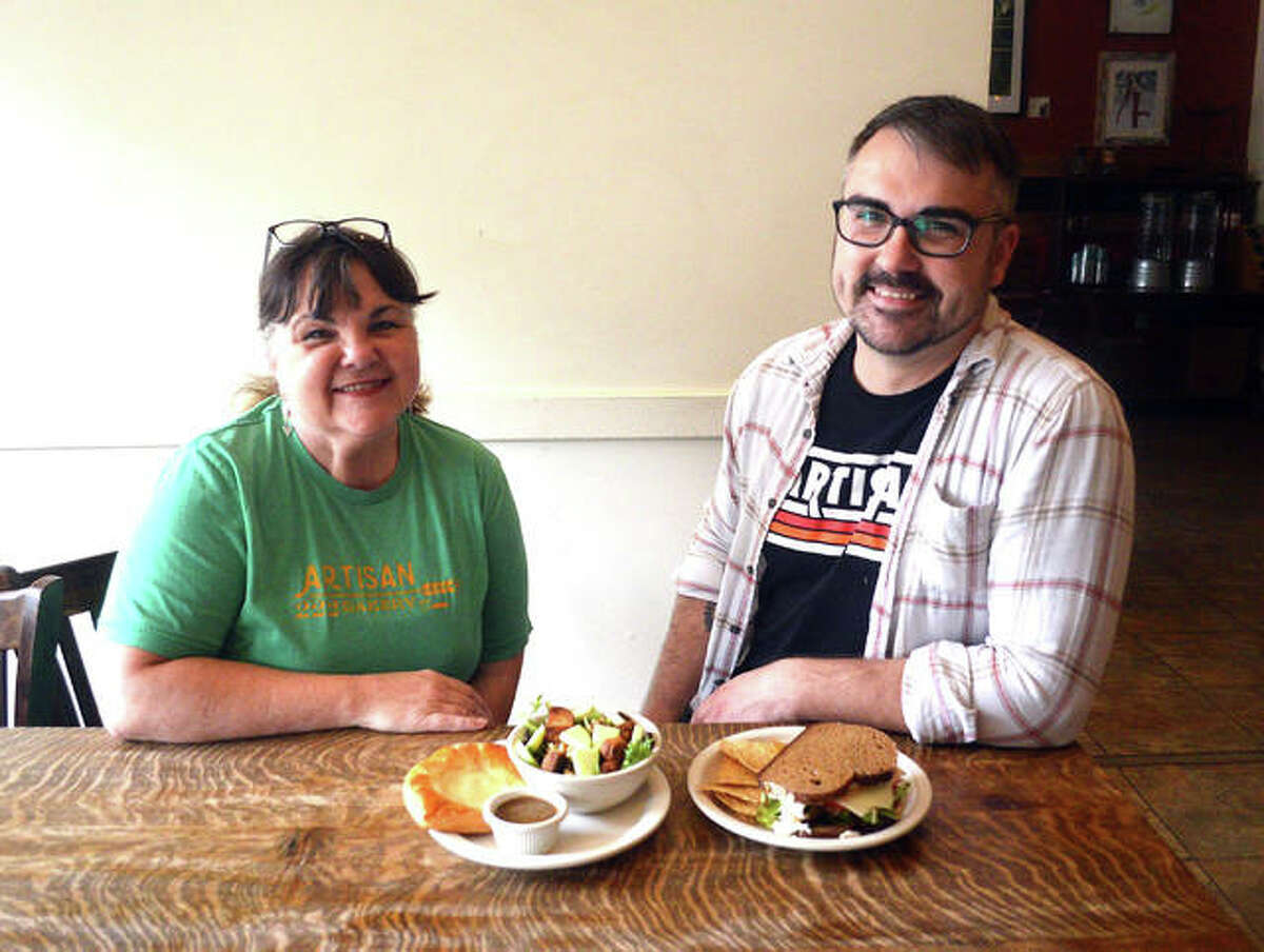 Kim Goodner, left, and Trevor Taynor , owners of 222 Artisan Bakery and Café, display the $10 turkey sandwich, house salad and pastry special, which is part of the SAVOR 2019 restaurant week campaign.