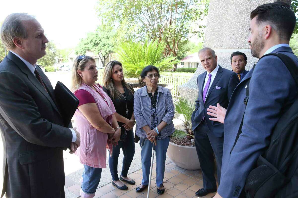 Julie Workman, from center left, Teresa Vidal and Maggie Vidal, listen to their attorneys as victims and relatives from the Sutherland Springs massacre gather outside the Federal Courthouse after an initial hearing on their lawsuit against the Air Force on Sept. 25, 2019. The three lawyers standing in the front, from left, are Brett Reynolds, Dan Sciano and Jamal Alfaffar.
