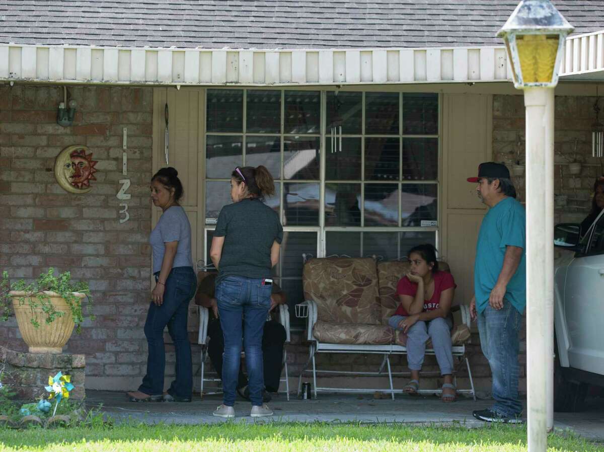 Family members gather at Ramiro and Rosalba Reyes' house on the 1100 block of Francitas Drive after the couple were shot to death outside the house overnight on Wednesday, Sept. 25, 2019, in Houston. The couple's son-in-law was also struck in the shooting and was in surgery Wednesday morning.