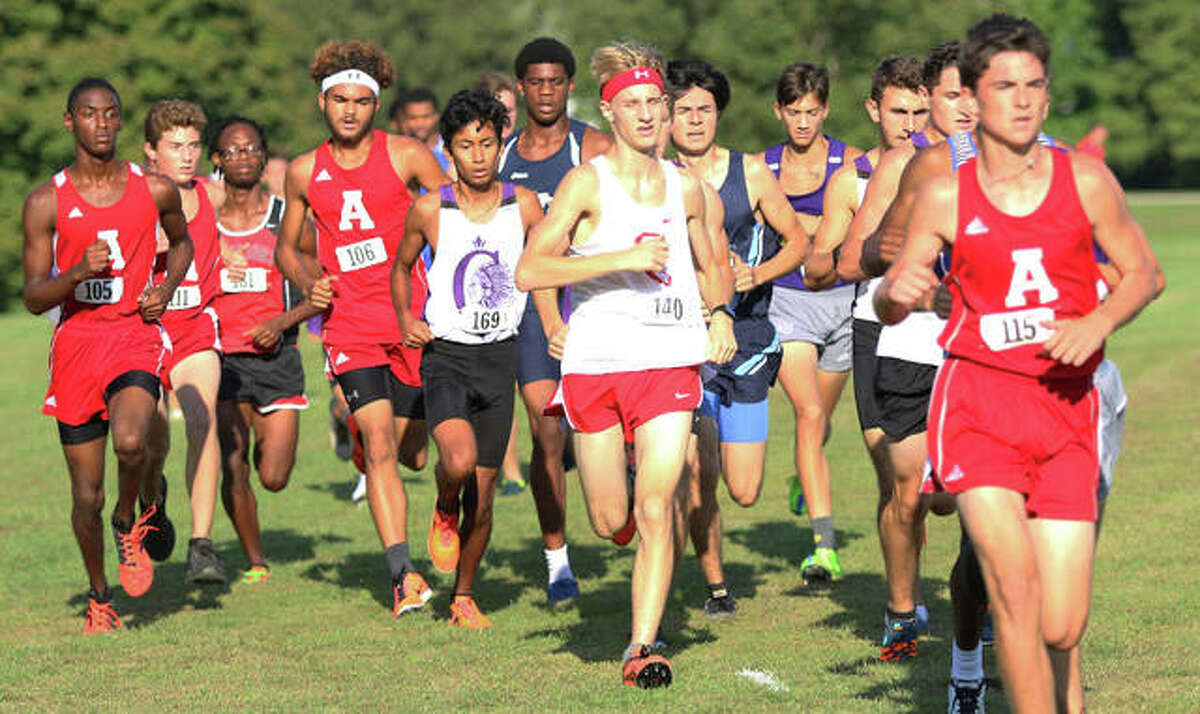 Alton’s Simon McClaine (right) leads a pack of runner behind the leaders after a half-mile into the three-mile Alton Invitational cross country meet Wednesday afternoon at Moore Park in Alton.