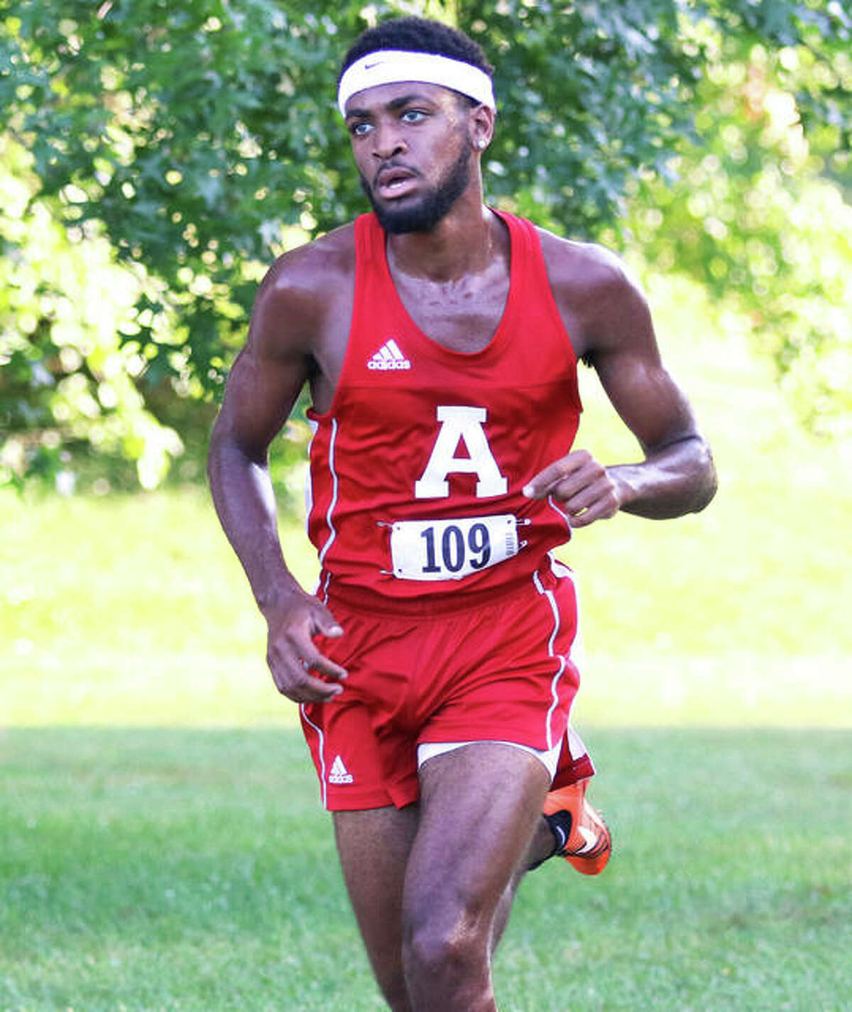 Alton senior Cassius Havis runs alone on the lead with about a half mile remaining in the Alton Invite on Wednesday at Moore Park.