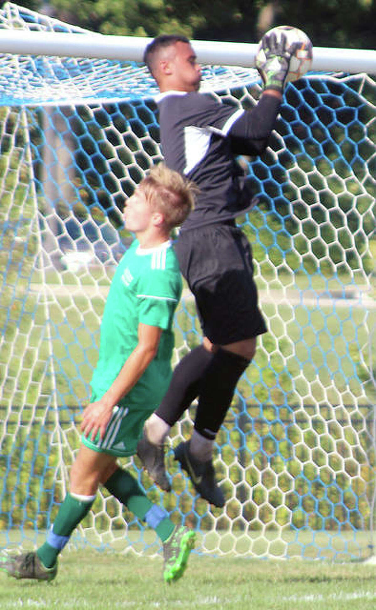 LCCC goalie Christian Deans grabs a a crossing pass intended for Jan Luca Behnke of John Wood College during Wednesday’s game at LCCC’s Tim Rooney Stadium. Deans made seven saves and helped the No. 20-ranked Trailblazers notch their second shutout of the season.