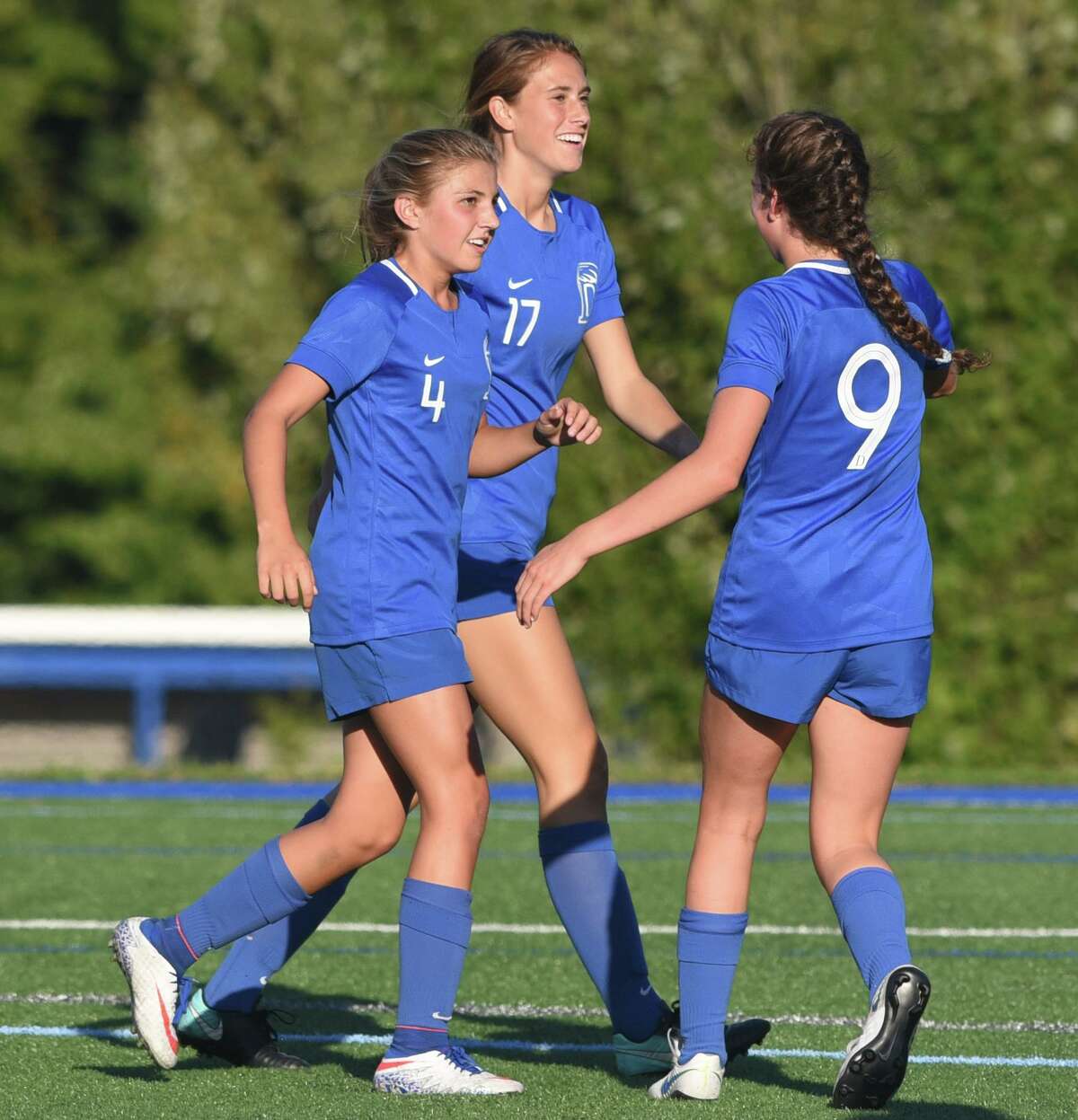 The Blue Wave, including Chloe Humphrey (4), Jordan Vaught (17) and Ceci Stein (9) celebrate a goal during a girls soccer game at Darien High School on Wednesday, Sept. 25, 2019.
