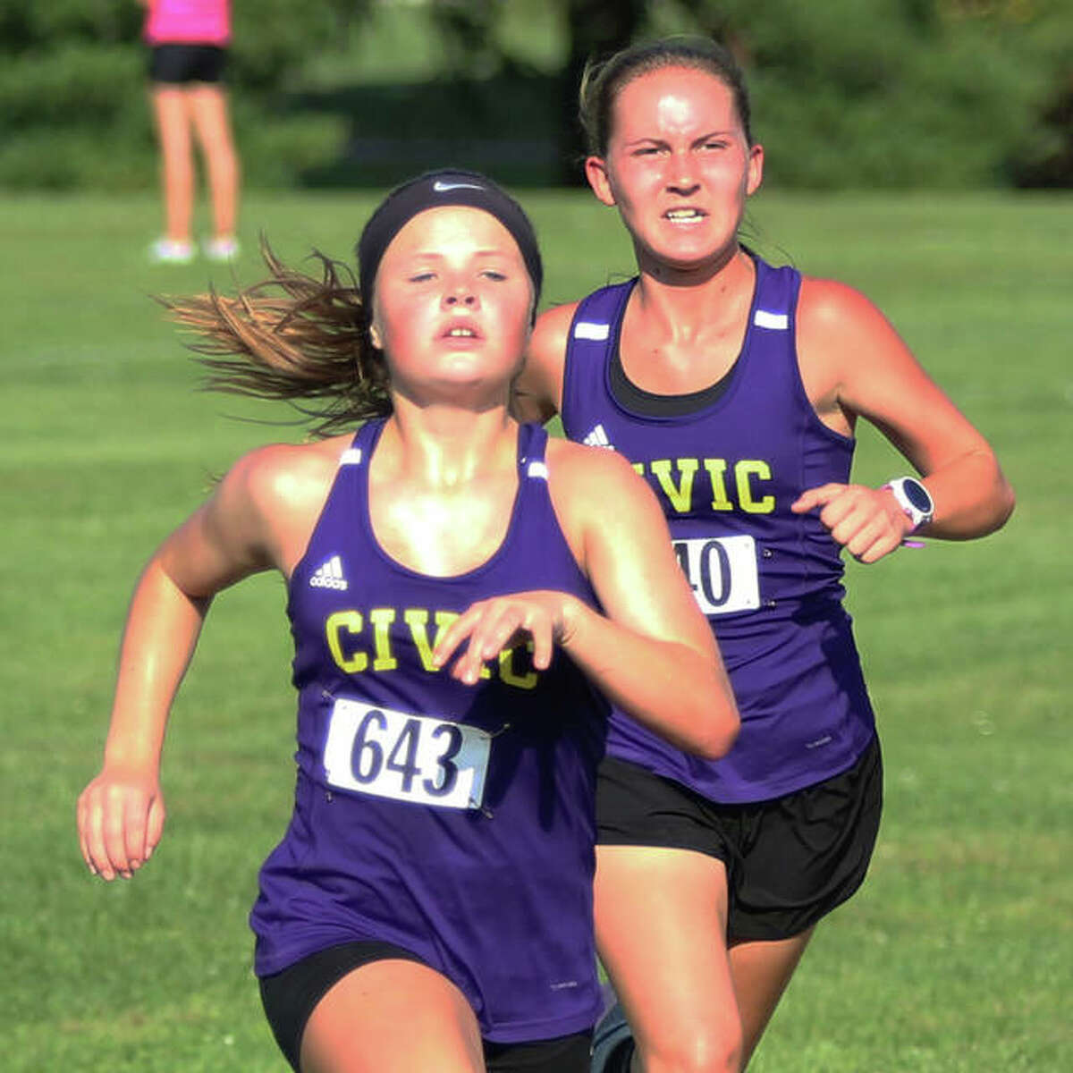CM’s Aubree Wallace (left) beats teammate Hannah Meiser to the finish Wednesday at the Alton Invite at Moore Park.