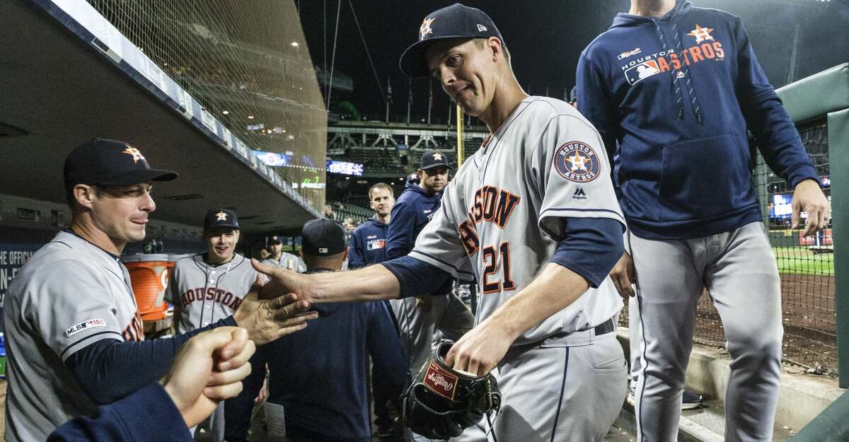 SEATTLE, WA - SEPTEMBER 25: Starting pitcher Zack Greinke #21 of the Houston Astros gets congratulations froma teammates and coaches as enters the dugout after pitching the sixth inning of a game against the Seattle Mariners at T-Mobile Park on September 25, 2019 in Seattle, Washington. (Photo by Stephen Brashear/Getty Images)